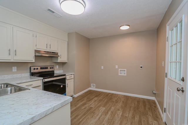 kitchen with light hardwood / wood-style floors, a textured ceiling, stainless steel electric stove, white cabinets, and sink