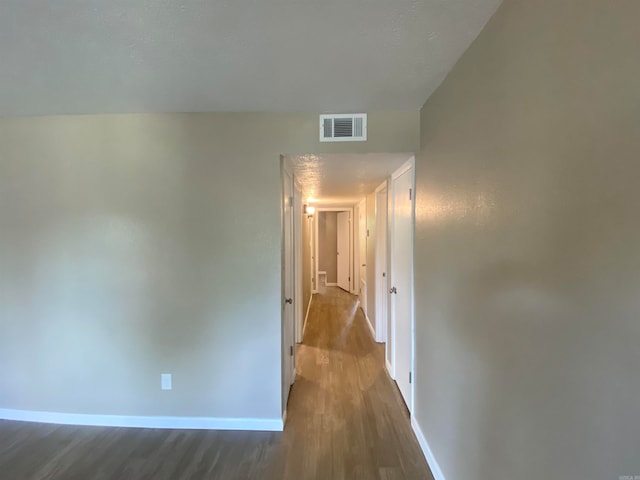 hallway with dark hardwood / wood-style floors