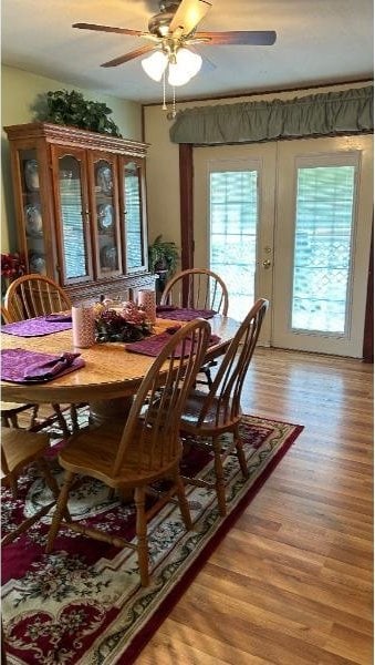 dining area with light hardwood / wood-style flooring and ceiling fan