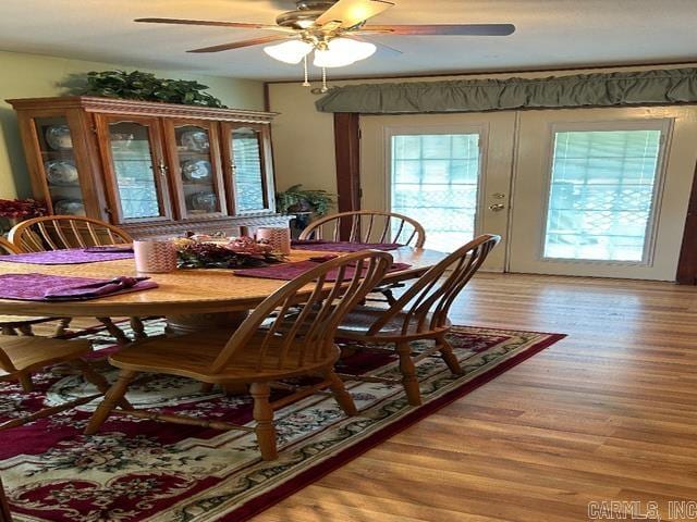 dining room with light hardwood / wood-style flooring and ceiling fan