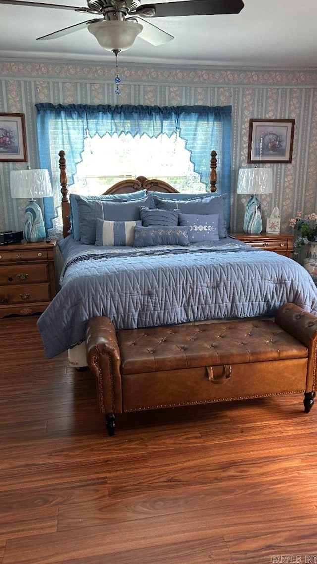 bedroom with crown molding, hardwood / wood-style floors, and ceiling fan