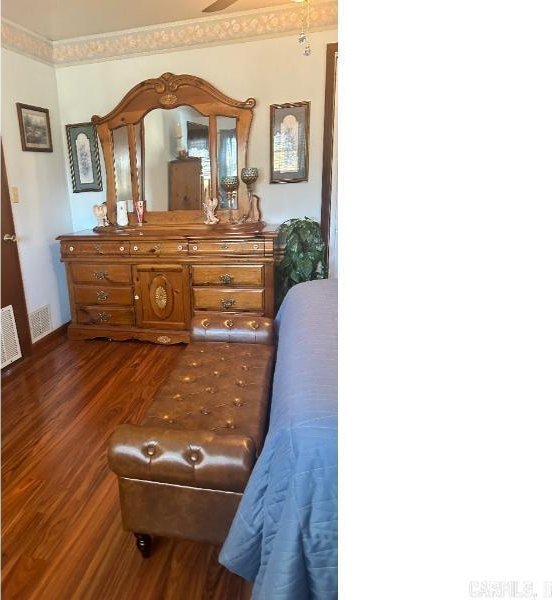 bedroom with dark wood-type flooring