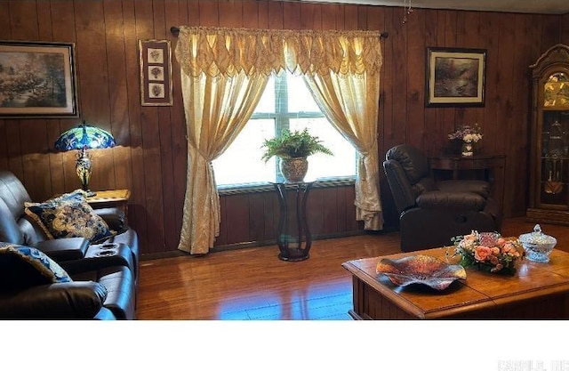 living room featuring hardwood / wood-style floors and wood walls