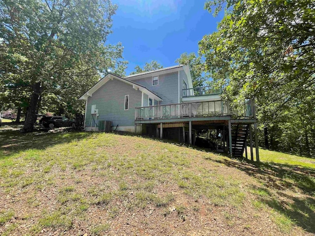 rear view of property featuring a deck and a yard