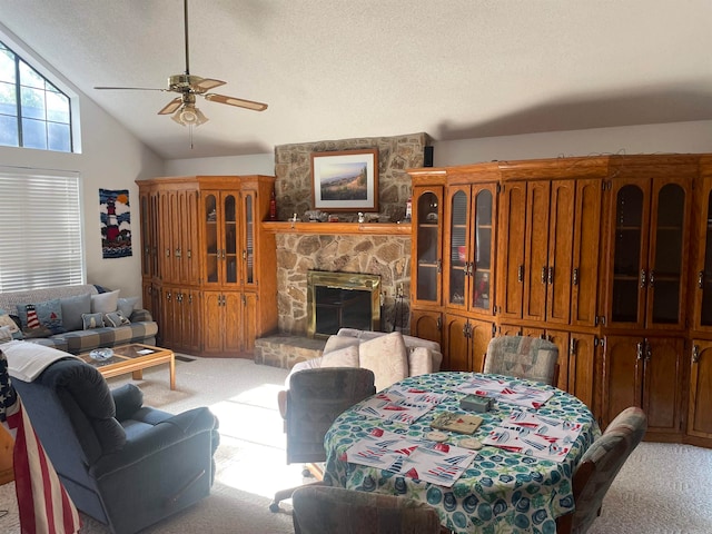 living room with ceiling fan, light carpet, a fireplace, and lofted ceiling