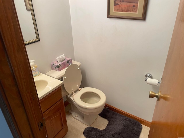 bathroom featuring vanity, toilet, and tile flooring