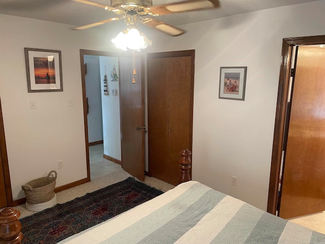 carpeted bedroom with a closet and ceiling fan