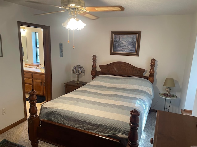 carpeted bedroom with ceiling fan and connected bathroom