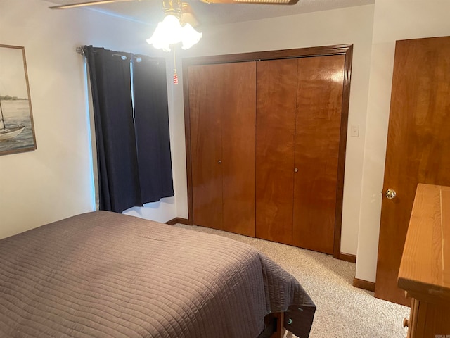 carpeted bedroom featuring a closet and ceiling fan