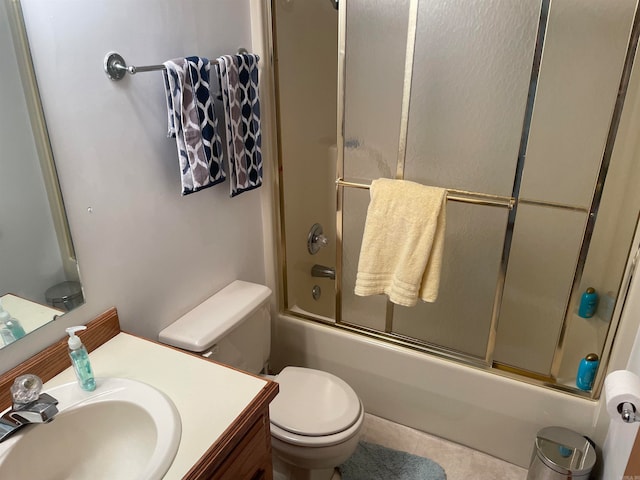 full bathroom with shower / bath combination with glass door, vanity, toilet, and tile flooring