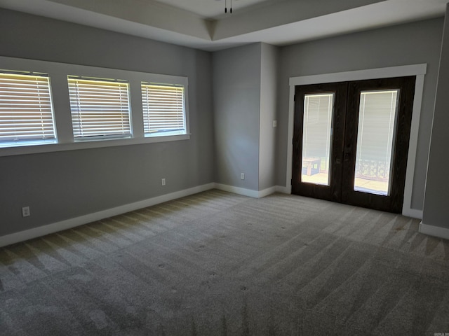 unfurnished room featuring a healthy amount of sunlight, french doors, and carpet floors