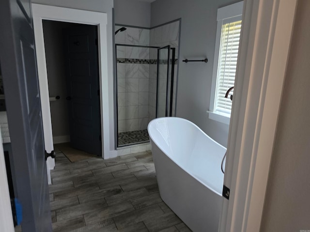 bathroom with plenty of natural light and separate shower and tub