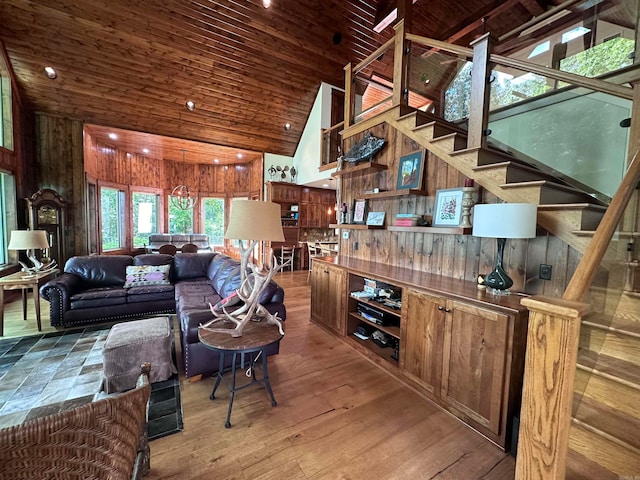 living room featuring wood ceiling, wood walls, wood-type flooring, and high vaulted ceiling