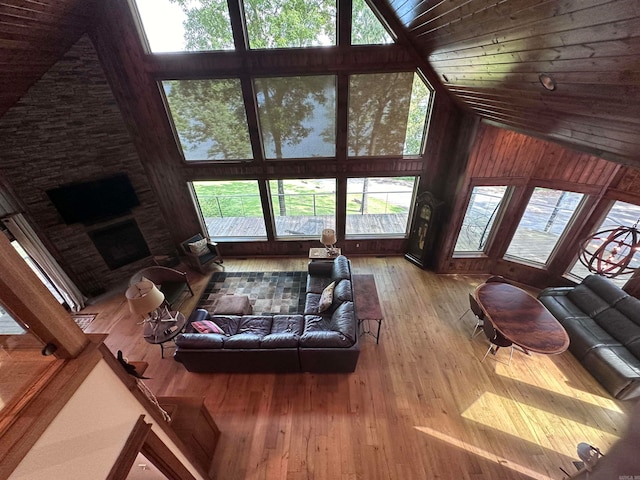living room featuring wood-type flooring, wooden ceiling, and high vaulted ceiling