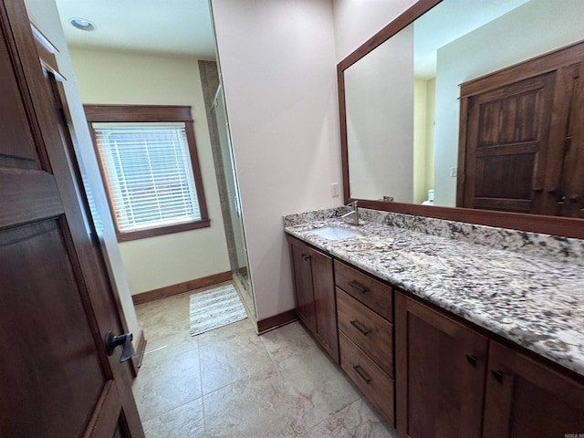 bathroom with tile flooring, vanity, toilet, and a shower with shower door