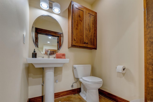 bathroom featuring tile floors and toilet
