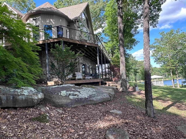 view of yard with a deck with water view