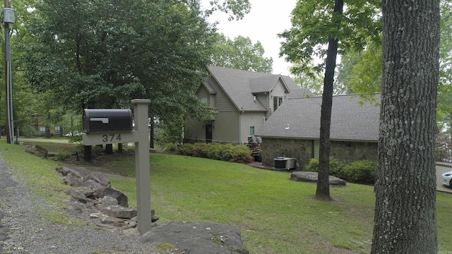exterior space featuring central AC and a yard