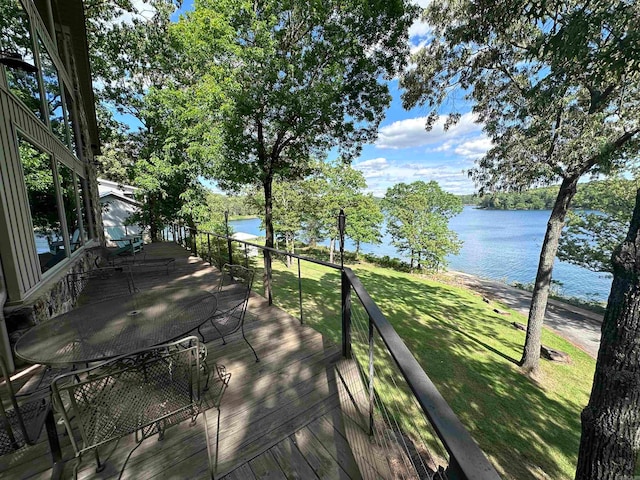 wooden terrace featuring a yard and a water view