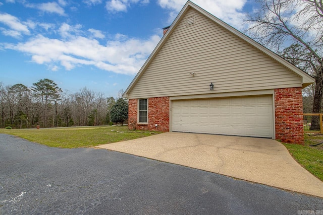 view of home's exterior with a garage and a lawn