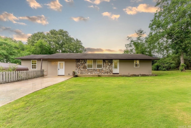 ranch-style home featuring a yard