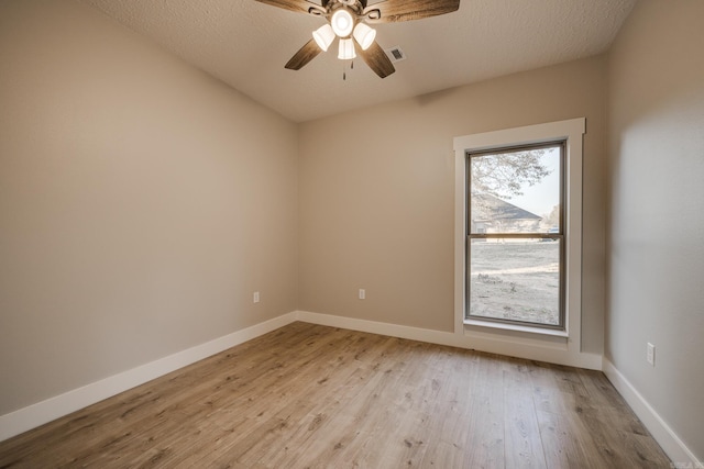 unfurnished room with ceiling fan, a textured ceiling, and light hardwood / wood-style floors