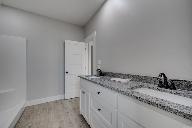 bathroom with vanity and hardwood / wood-style floors