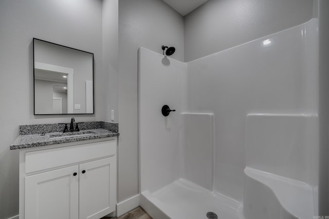 bathroom with vanity and a shower