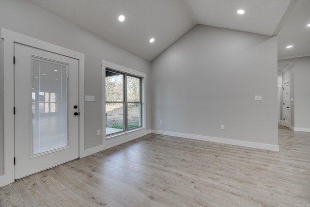 interior space featuring lofted ceiling and light wood-type flooring