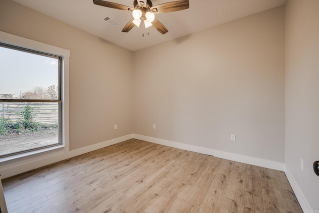 empty room featuring ceiling fan and light hardwood / wood-style flooring