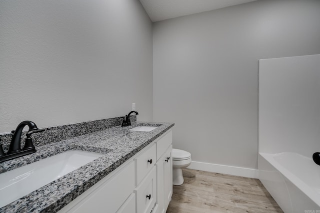 bathroom with vanity, hardwood / wood-style floors, and toilet