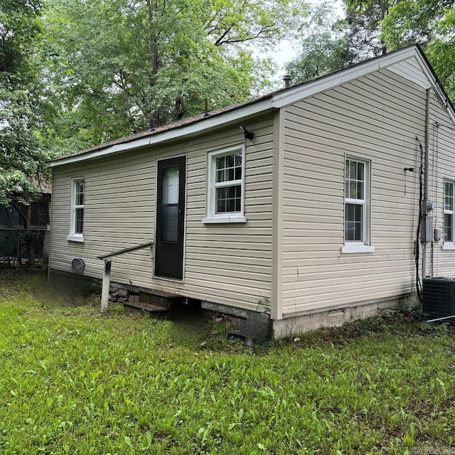 rear view of property featuring a yard