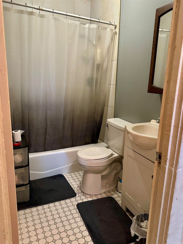 full bathroom featuring tile patterned floors, vanity, toilet, and shower / tub combo with curtain