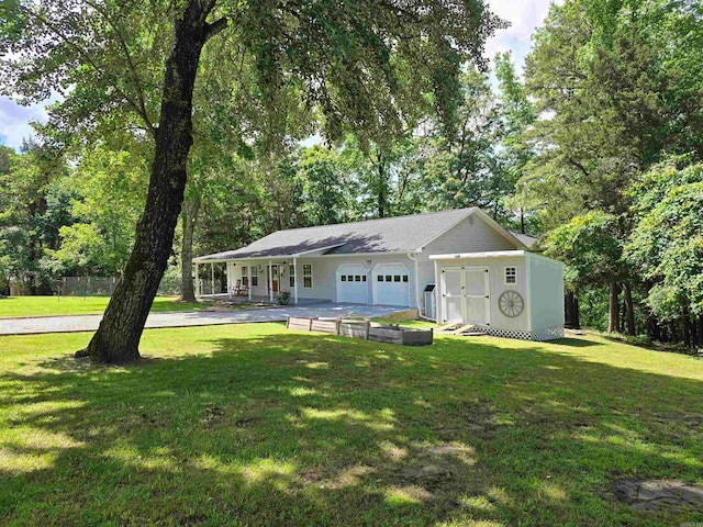 ranch-style house featuring a garage, a front yard, and covered porch