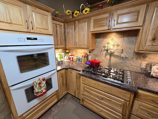 kitchen with double oven, backsplash, and stainless steel gas cooktop