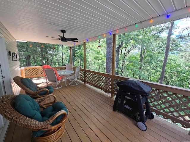 wooden deck featuring ceiling fan and area for grilling