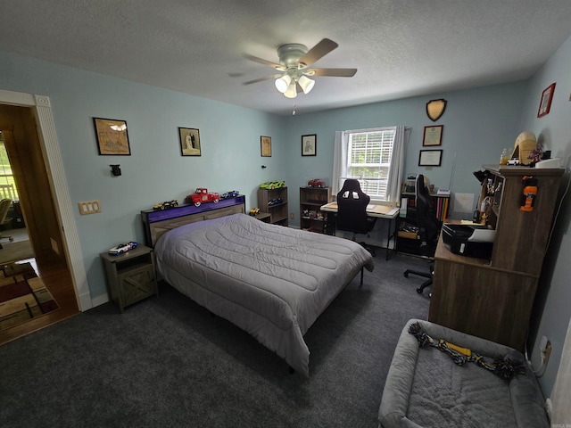 carpeted bedroom with ceiling fan and a textured ceiling