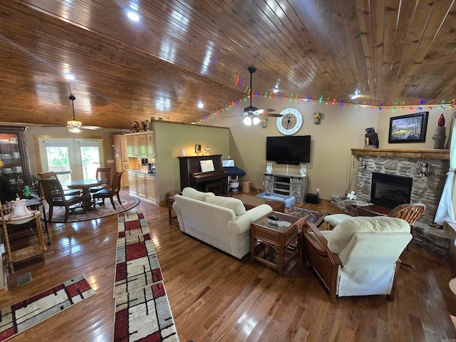 living room featuring a stone fireplace, wooden ceiling, wood-type flooring, and ceiling fan