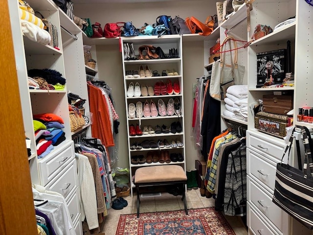 walk in closet with tile floors