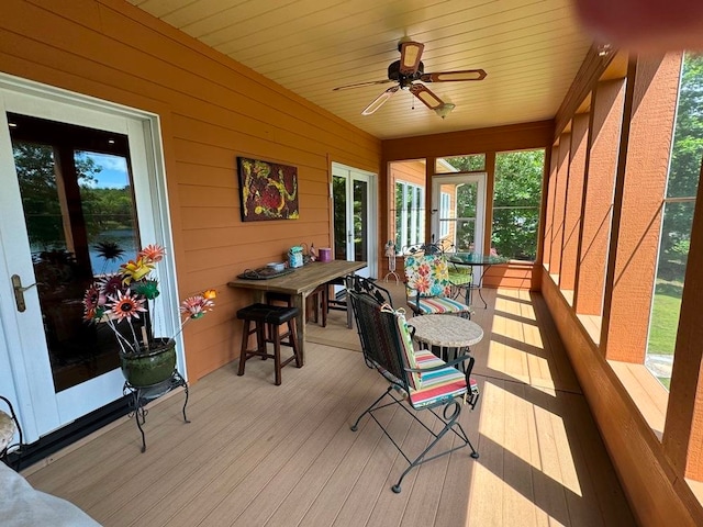 sunroom / solarium featuring ceiling fan