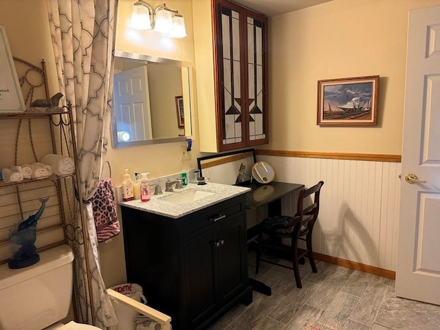 bathroom with hardwood / wood-style floors, toilet, and large vanity