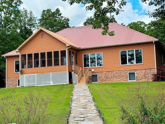 view of front of house with a front lawn and a sunroom