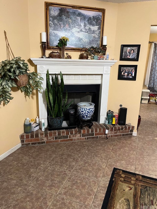 room details featuring tile patterned flooring and a brick fireplace