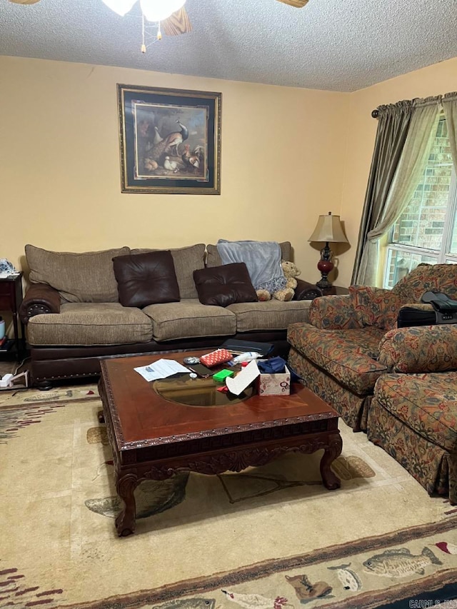 carpeted living room featuring a textured ceiling and ceiling fan