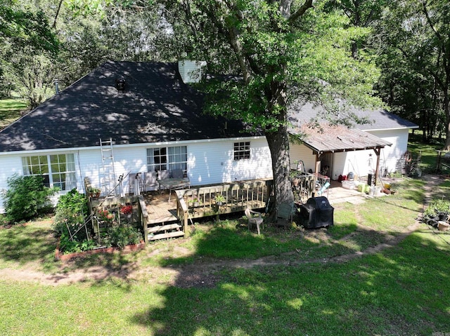 view of front facade with a front lawn and a deck