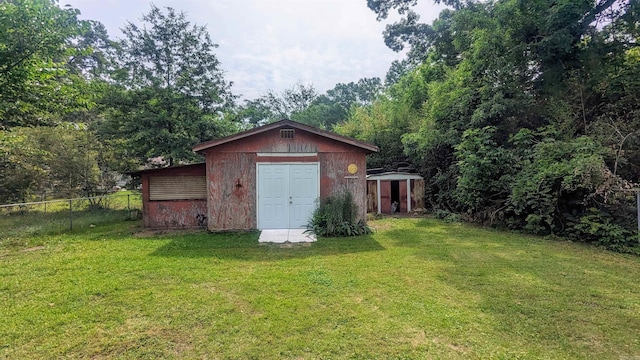 view of outbuilding with a yard