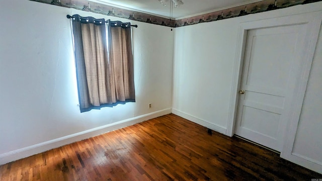 unfurnished room featuring dark wood-type flooring