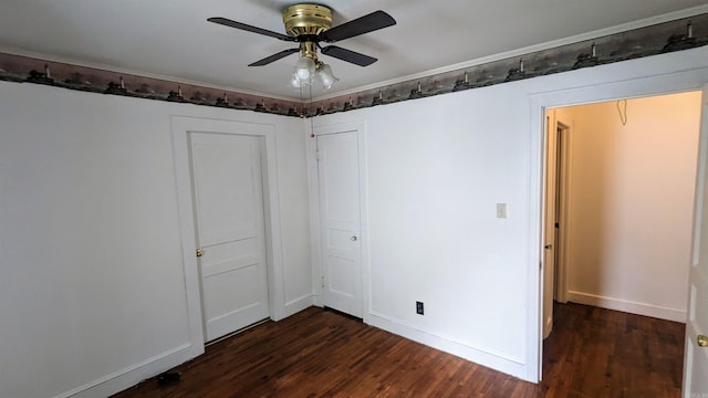 spare room featuring dark wood-type flooring and ceiling fan