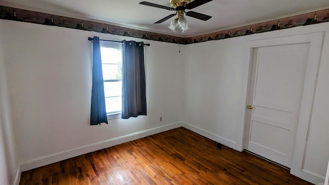 spare room with dark hardwood / wood-style floors and ceiling fan