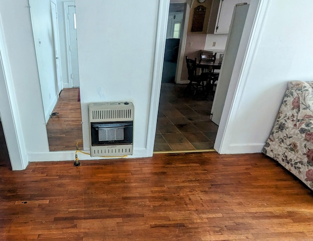 corridor featuring heating unit and hardwood / wood-style floors